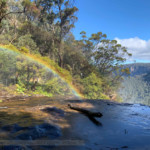 A rainbow atop the Waterfall on a sunny day.